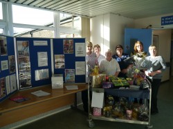 Staff at the Dignity Action Day information stand with raffle prizes