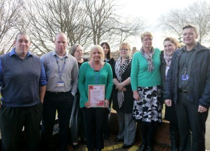 The dementia service team with their accreditation certificate