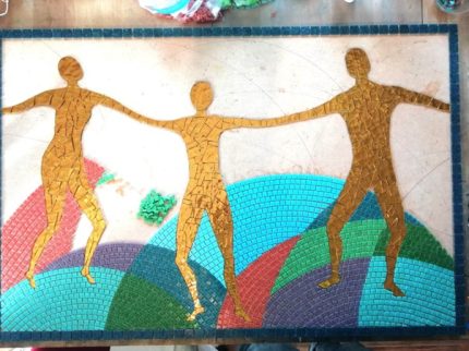 Image of a mosaic of three people holding hands.
