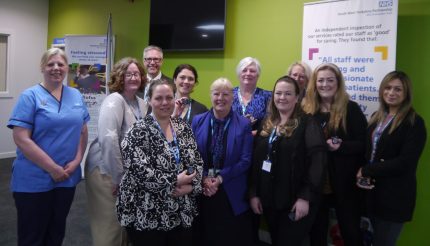 A picture taken of the team of perinatal peer support workers with their award badges.