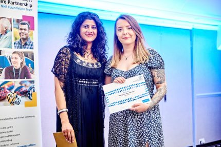 Amy Willis on stage to receive her highly commended certificate for rising star with Dr Subhna Thiyagesh