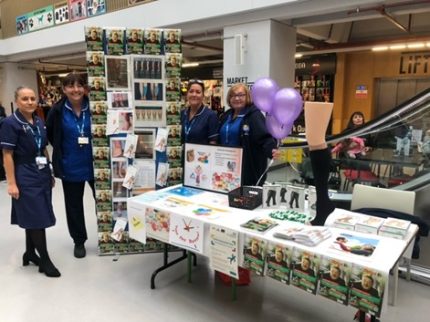 Four people at an information stand