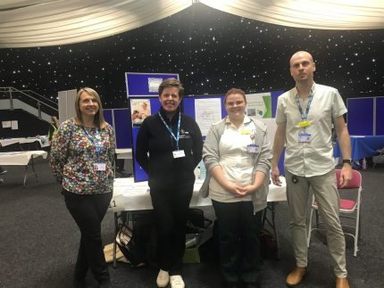 A group of people standing at a careers event
