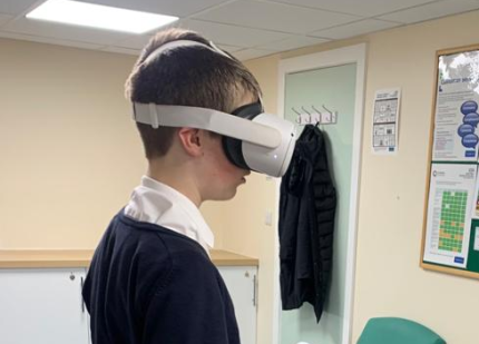 A photo of a young person wearing a virtual reality headset
