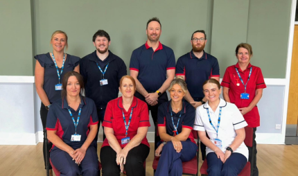 Photo of group of people wearing blue and red nursing uniform