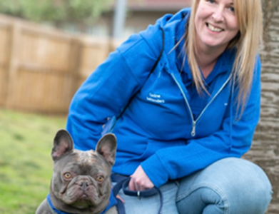 Image of Lisa and Ernie the dog who volunteer at the Trust as canine befrienders.