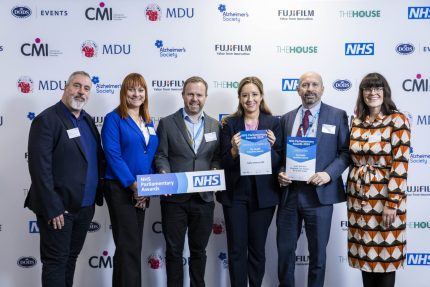 A group of people at an awards ceremony.