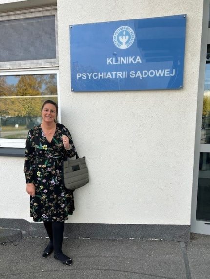 A woman stood outside a blue sign