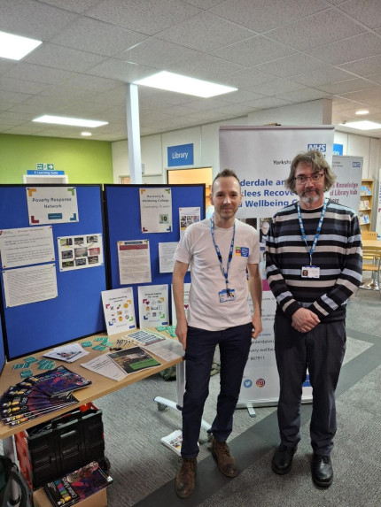 Photo of two people at stand