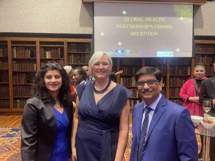 Photo of three people at an awards ceremony