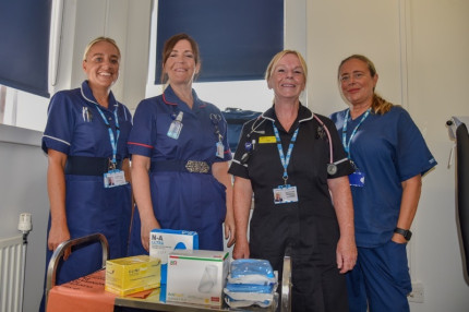 Four nurses standing together.