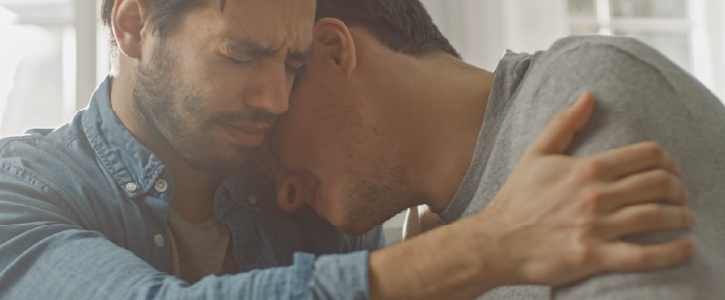 2 men consoling each other