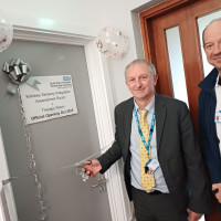 Chief executive Mark Brooks and colleague standing to cut the ribbon to open the Kirklees sensory room