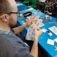 Person overlaying a craft frame with paper