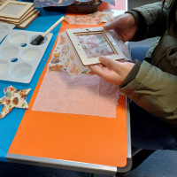 Person holding a craft frame