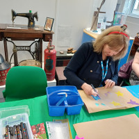 Person colouring a star on a paper
