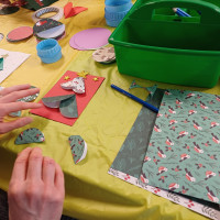 Person creating paper Christmas tree card