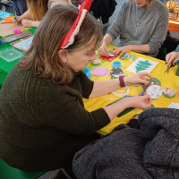 Person holding paper circles and showing them to another