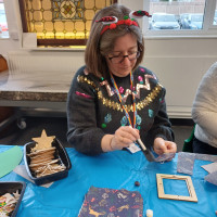 Person sat applying glue to a craft