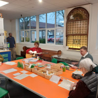 Group of people sat at a table singing