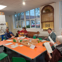 Group of people sat at a table singing