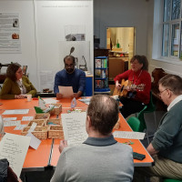 Group of people sat at table singing