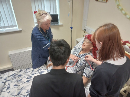 Photo of nurse and student working with simulation person