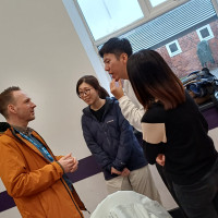 Recovery College Hong Kong delegation visit - four people talking
