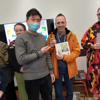 Recovery College Hong Kong delegation visit - two people standing with object