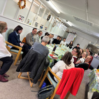 People sat around a table making crafts
