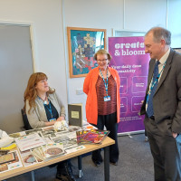 Chief Executive Mark Brooks and Chair Marie Burnham speaking to a colleague at their stall