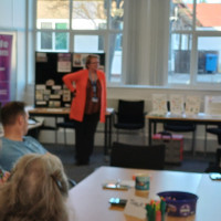 Chair Marie Burnham standing talking to the audience