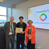 Chief Executive Mark Brooks and Chair Marie Burnham standing with connector and their certificate