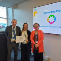 Chief Executive Mark Brooks and Chair Marie Burnham standing with connector and their certificate
