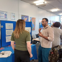 Two people talking at a stall