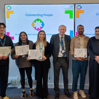 Chief Executive Mark Brooks and Chair Marie Burnham standing with our newly qualified community connectors holding their certificates