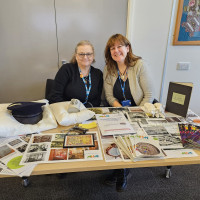 Two colleagues sat at a stall