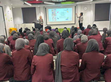 Two colleagues presenting a presentation about apprenticeships to an audience of students