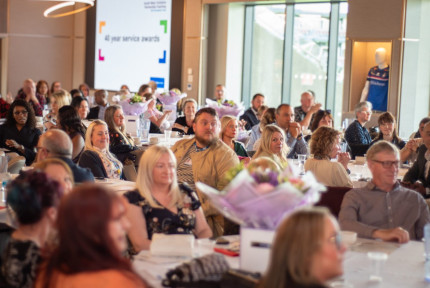 a room full of people in an awards ceremony