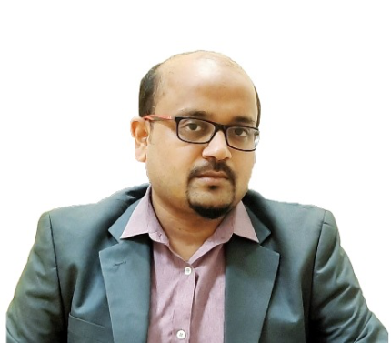 Dr Tanay Maiti, a man wearing glasses and a suit