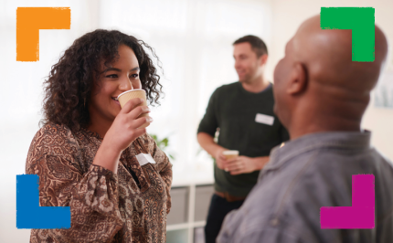 Person holding cup in conversation with another person